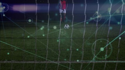 Animation of network of connections over mid section of male soccer player taking a penalty kick - Powered by Adobe