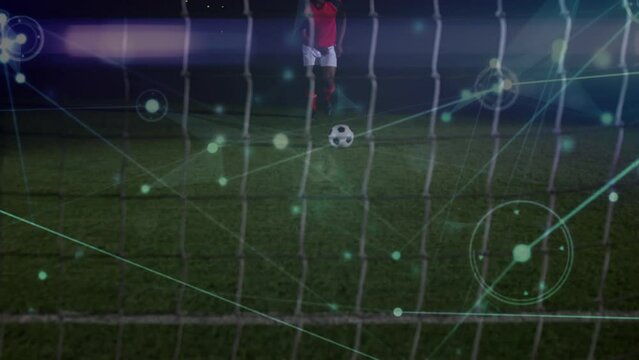 Animation of network of connections over mid section of male soccer player taking a penalty kick