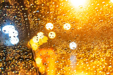 Blurred image of a car on the road on a rainy day.