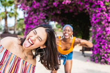 Positive multiracial lesbian women having fun in park