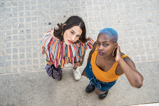 Stylish multiethnic couple of lesbian women in city