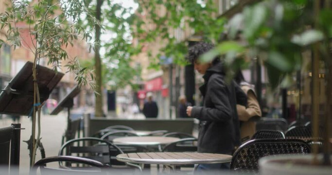 MS Female couple sitting at table in sidewalk cafe