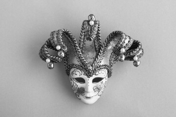 Venetian carnival mask in the center of the gray background. Top view. Copy space.