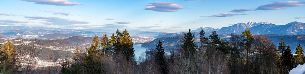View from the parking lot of the Pyramidenkogel to the snowy mountains and the Wörthersee in Carinthia, Austria