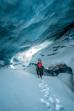 Woman walking through ice cave in Plaine Morte Glacier, Switzerland