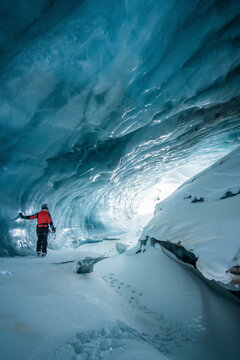 Woman standing in an ice cave in Plaine Morte Glacier, Switzerland