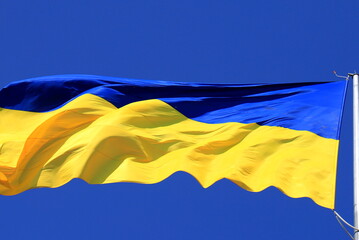 Flag of Ukraine in blue sky. Large yellow blue Ukrainian national state flag, city Kyiv. Independence Constitution Defender Day of Ukraine