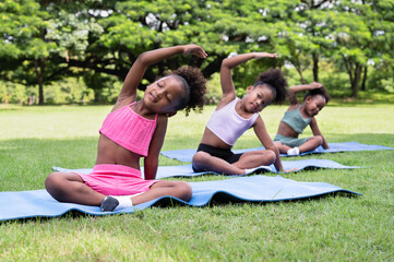 Training yoga African American kids girl at garden	