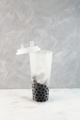 Chewy Tapioca balls Boba or Pearls in tall plastic take away cup. Preparating popular Taiwanese...