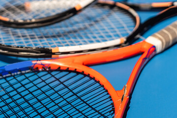 broken tennis rackets blue tennis court