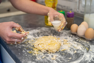 breaking eggs with women's hands into flour to make dough for cakes.