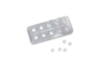 An open blister with tablets and five tablets nearby