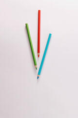 Colored wooden pencils on a gray background, minimal back to school concept, red, green, blue