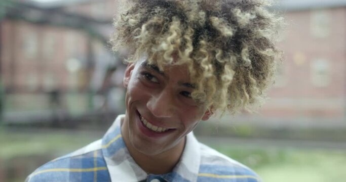 CU Smiling young man with curly hair