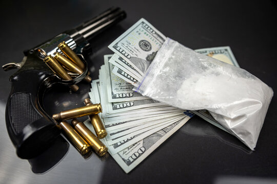 Plastic bags of cocaine, US dollar bills with a gun.