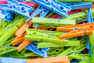 Pile of colorful clothespins. Close-up of various clothes pegs.
