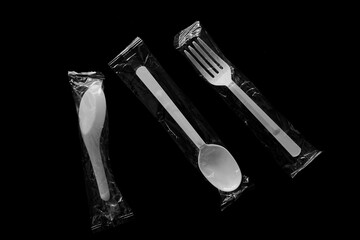 spoon and fork on black background