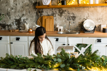 Portrait of a laughing little girl holding Christmas decoration in hands
