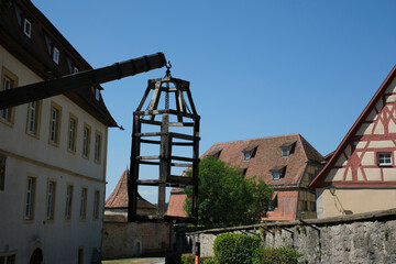 Courtyard of Medieval Crime Museum, wooden torture cage, device for torturing witches with water,...