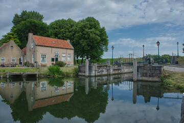 Obraz premium Drainage lock Dirkslandse Sas built in 1790-1791 is located at the end of the Westhavendijk in Goeree-Overflakkee near the Dutch city of Middelharnis, South Holland, The Netherlands.