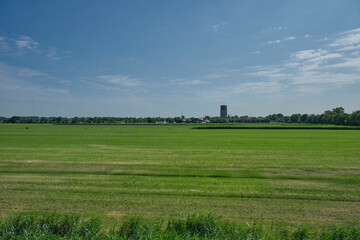 Panoramic view of a classic polder landscape and a village in the western part of the Netherlands