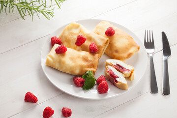 Pancake with cheese and raspberries