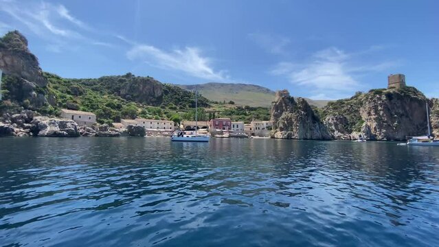 Scopello and its Tonnare seen from the clear sea in the Zingaro nature reserve in Sicily