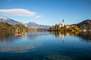 Fototapeta na wymiar Panoramic view of Julian Alps, Lake Bled with St. Marys Church of the Assumption on the small island. Bled, Slovenia, Europe.