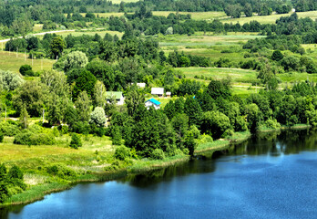 Village house in the forest near the lake. Lake in the countryside with rural houses. Rural...