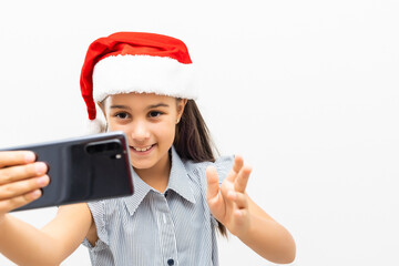 little girl in santa hat with smartphone on white background