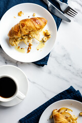 Morning coffee with croissants stuffed with caramelized pear, hazelnuts, and ricotta.