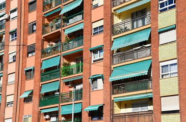 Fototapeta premium Facade of a building. Residential building with balconies and windows. Colorful buildings apartments. House with window and balcony. Buildings architecture in Europe..
