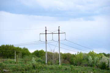 Steel pillar with high voltage electric power lines delivering electrical energy through cable wires on long distance
