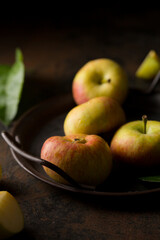 apples on a metal tray on a dark