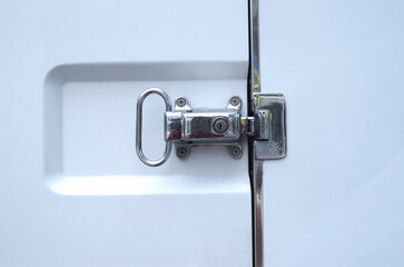 Closed white refrigerated truck door lock close