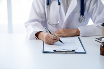 Doctors looking at patient's diagnostic documentation in the hospital's medical room, treating diseases from specialists and providing targeted treatment. Concepts of medical treatment and specialists