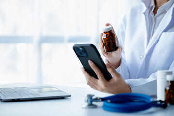 Doctors print reports on smartphones in the hospital's medical room, treating diseases from specialists and providing targeted treatment. Concepts of medical treatment and specialists.