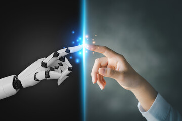 Robot and human hands pointing to each other, the idea of creating futuristic AI, intelligent systems to work instead of humans and do what humans can't. Creating innovative technology of the future.