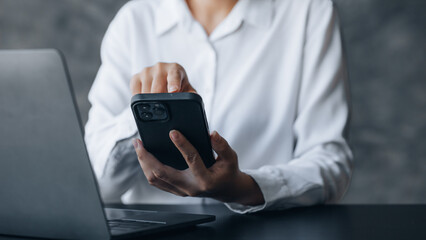 A person is using a smartphone to chat with friends through an application, telecommunication via the Internet on a mobile phone. Concept of using technology in communication.