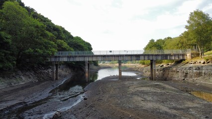 Bridge over a reservoir with low water levels due to the hot dry weather in England. Taken in Bolton Lancashire. 