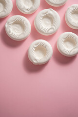 Empty meringue nests placed on a pink background