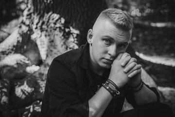 Young European man with a sad philosophical mood. The concept of life, problems and depression. Crisis of young age