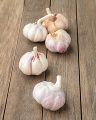 A group of garlic bulbs over wooden table
