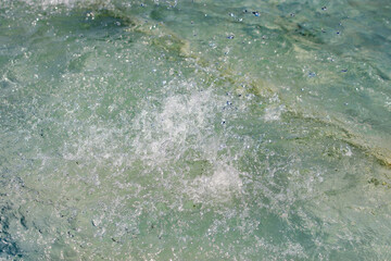 Close up to a river clean and transparent water surface with ripples