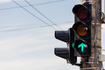 Traffic semaphore with arrow sign on green light for those that drive ahead