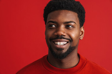 Obraz premium Black bearded young man smiling and looking aside