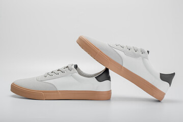 White leather men sneakers isolated on gray background. Fashionable stylish sports casual shoes....