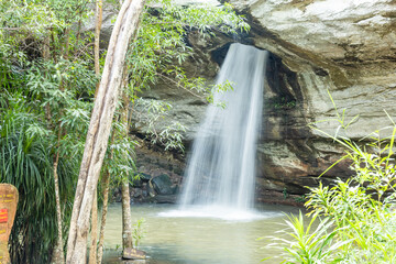 Saeng Chan waterfall in the deep humid forest at Ubon Ratchathani, Thailand, Leaf moving low-speed shutter blur.