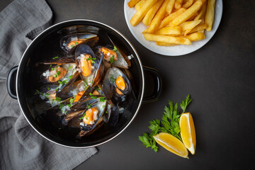 Delicious seafood mussels with parsley sauce and lemon. Delicious steamed mussels.