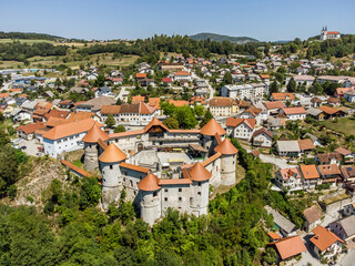 Aerial drone view of Medieval castle of Zuzemberk or Seisenburg or Sosenberch, positioned on terrace above the Krka River Canyon, Central Slovenia.